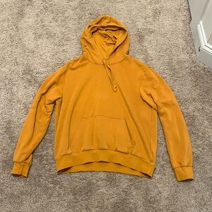This is a mustard colored H&M hoodie.
